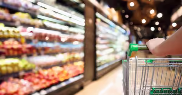 woman holds grocery cart in superstore