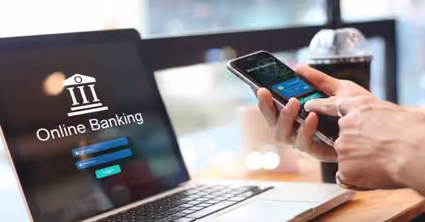 man using online banking with credit card on touch screen device